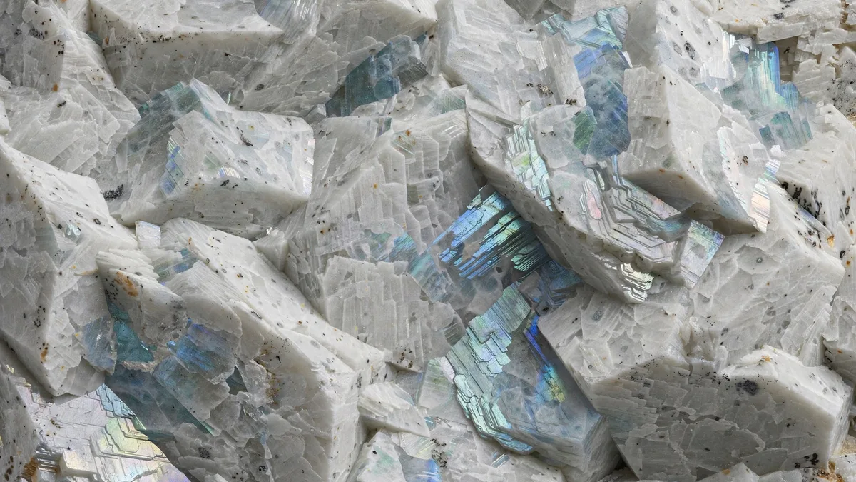 Close-up illustration of pale anorthosite rock showing large interlocking feldspar crystals