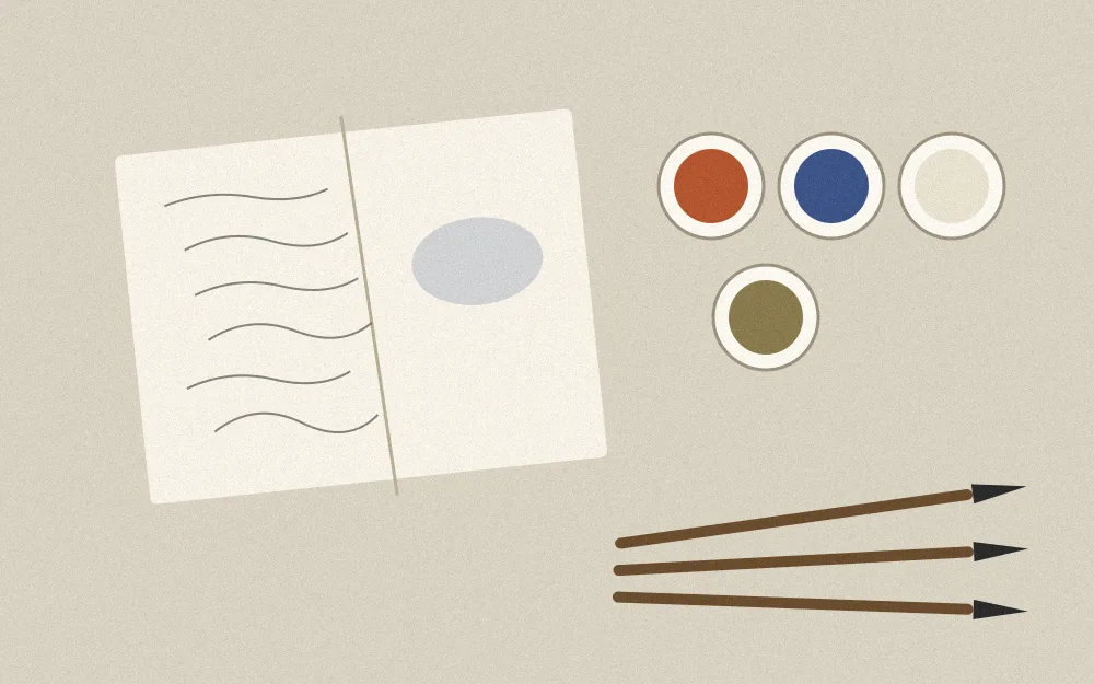 Top-down view of an artist’s table with an open sketchbook, four bowls of handmade pigment and three brushes
