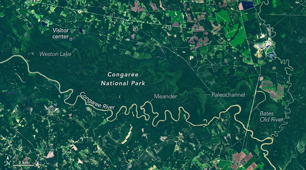 Labeled Landsat 9 satellite image of the Congaree River winding through dark green floodplain forest, with Weston Lake, Bates Old River and the visitor center marked