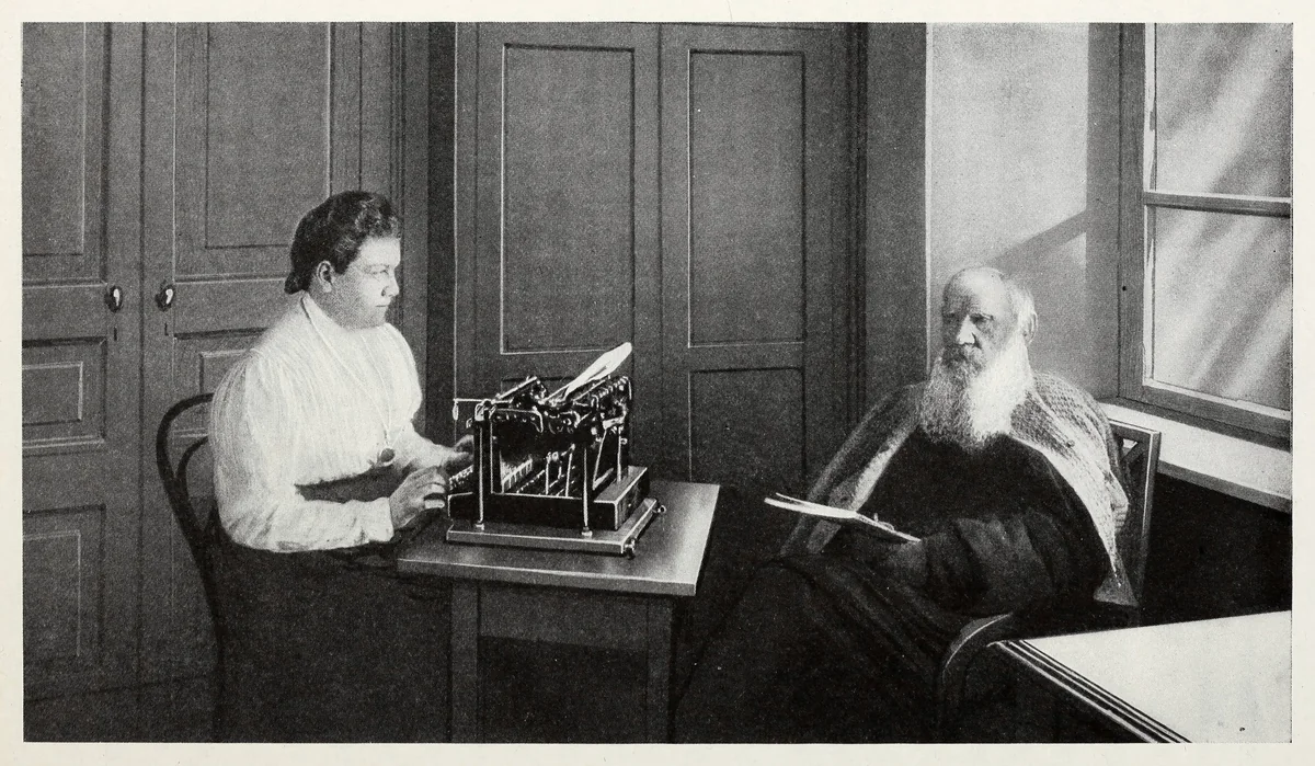 Photograph of Count Tolstoy dictating to his daughter, who types on a typewriter, from a 1923 book